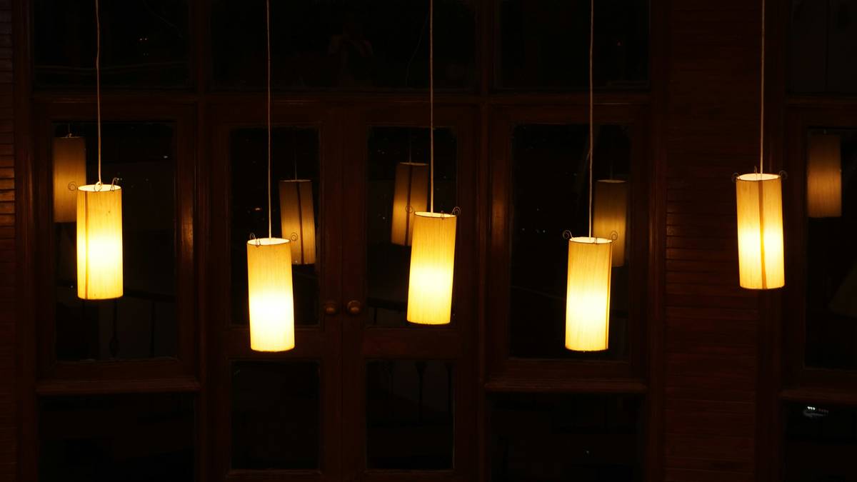 hotel restaurant lighting fixtures illuminating a modern dining room with warm ambient and accent lights
