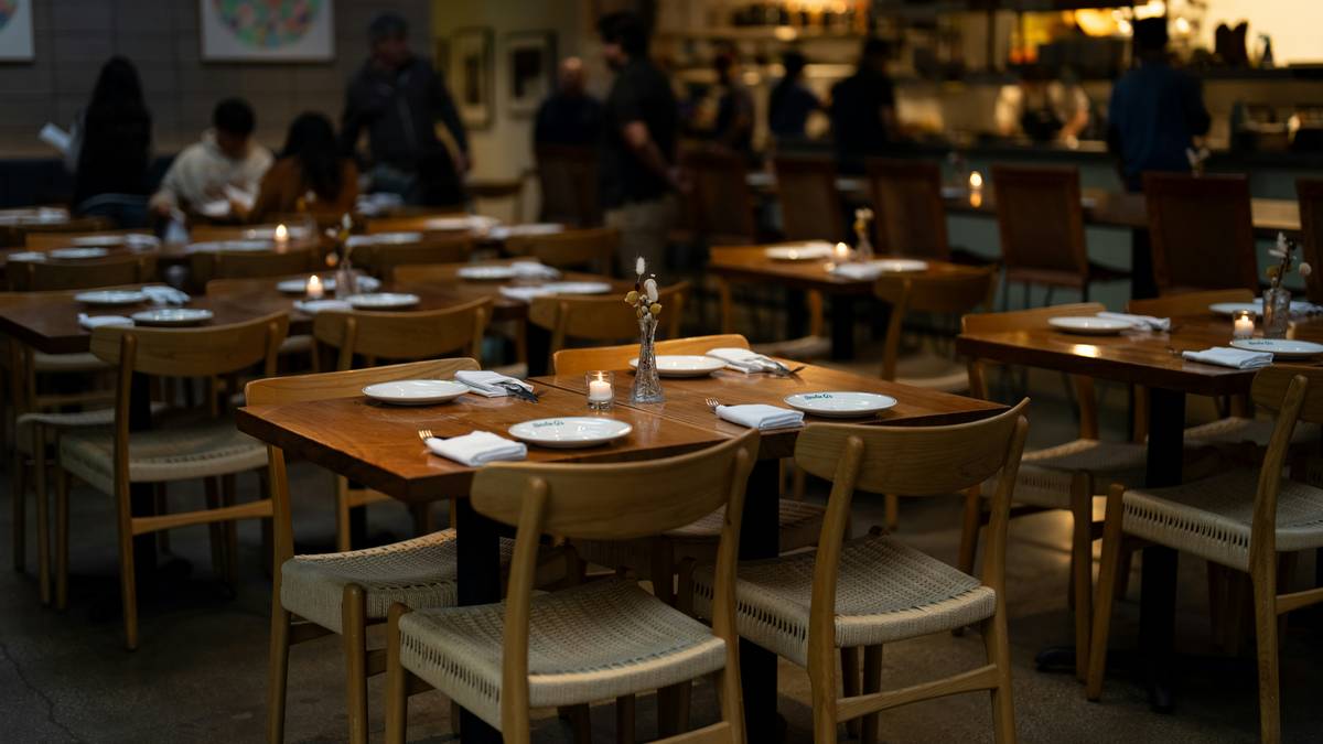 mood restaurant los angeles with layered ambient and accent lighting illuminating intimate dining booths